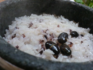 １．石鍋で出てきた豆ご飯をお茶碗によそったら、ここに水を注ぎます