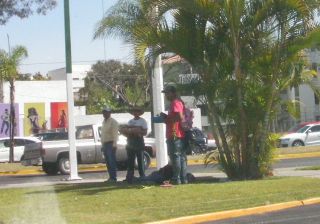 交差点ですべての荷物を背負って幸運を待つ