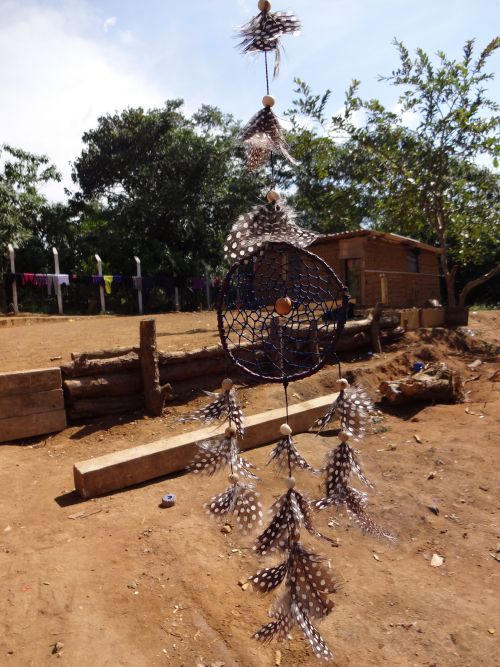 蜘蛛の巣のような飾りに、鳥の羽をぶら下げたインディオ由来の魔よけ