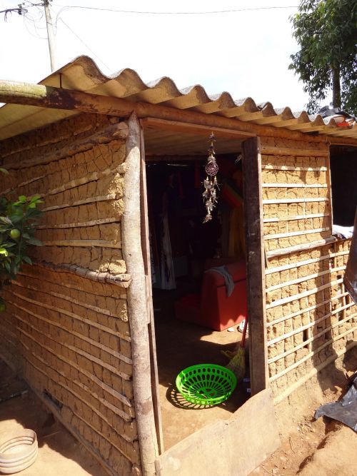 インディオ由来の蜘蛛の巣模様と羽の魔よけを建物の入口につるすインディオの村の民家の様子